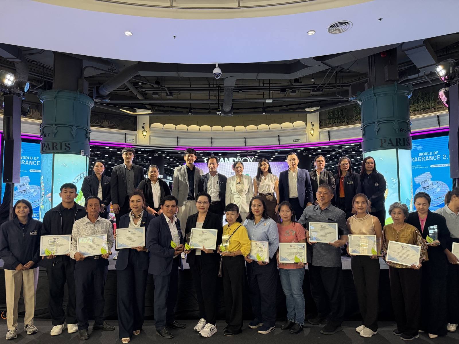 Business owners receiving certificates at a DIPROM event